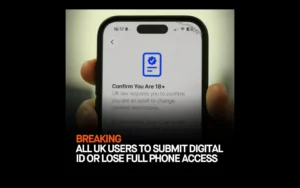 A hand holding a smartphone displaying an age verification screen with text that reads "Confirm You Are 18+ UK law requires you to confirm you are an adult to change content restrictions," with a bold news banner across the bottom reading "BREAKING: ALL UK USERS TO SUBMIT DIGITAL ID OR LOSE FULL PHONE ACCESS."